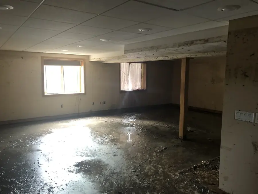 Standing floodwater on a Circle Pines basement floor after a sump pump failure